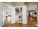 Laundry closet with white front load washer and dryer in hallway with hardwood floors at 320 Jessica Way, Canton, GA 30114