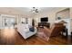 Comfortable living room featuring hardwood floors, a fireplace, and a cozy seating area at 320 Jessica Way, Canton, GA 30114