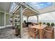 Outdoor kitchen and dining area with stone countertop, grill, pergola and brick patio at 320 Jessica Way, Canton, GA 30114