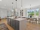 Modern kitchen with stainless steel appliances, a large center island, and an adjacent dining area at 401 Nettle Ct, Woodstock, GA 30188