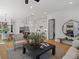 Open-concept living room showcasing hardwood floors, recessed lighting, and seamless transition to the modern kitchen at 401 Nettle Ct, Woodstock, GA 30188