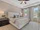 Serene main bedroom featuring tray ceilings, neutral walls, plush carpeting, and large windows with natural light at 401 Nettle Ct, Woodstock, GA 30188