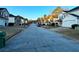 Quiet street view of a suburban neighborhood featuring well-kept homes and manicured lawns at 4547 Carriage Park Dr, Lithonia, GA 30038