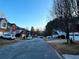 Street view of a suburban neighborhood with well-maintained homes and cars parked in driveways at 4547 Carriage Park Dr, Lithonia, GA 30038