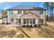 The backyard has a well-maintained lawn, complimented by the home's neutral brick exterior and dark roof at 5269 Heron Bay Blvd, Locust Grove, GA 30248