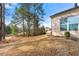 Landscaped backyard with a view of trees and neighboring homes at 5269 Heron Bay Blvd, Locust Grove, GA 30248