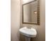 Bathroom with pedestal sink and framed mirror at 5269 Heron Bay Blvd, Locust Grove, GA 30248