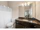 Bathroom featuring a granite countertop vanity and toilet with shower featuring a shower curtain at 5269 Heron Bay Blvd, Locust Grove, GA 30248