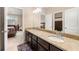 Double vanity bathroom with granite countertops and a view into bedroom at 5269 Heron Bay Blvd, Locust Grove, GA 30248