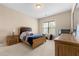 Well-lit bedroom with wood furniture and carpet flooring at 5269 Heron Bay Blvd, Locust Grove, GA 30248