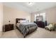 Bedroom with neutral paint, vaulted ceilings, and bedside table at 5269 Heron Bay Blvd, Locust Grove, GA 30248