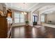 Bright dining room with hardwood floors and a view of the entryway and living areas at 5269 Heron Bay Blvd, Locust Grove, GA 30248