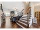 Elegant entryway featuring hardwood floors, staircase with iron railing, and open access to the living areas at 5269 Heron Bay Blvd, Locust Grove, GA 30248