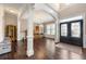 Bright entryway with hardwood floors, decorative columns, and elegant double doors at 5269 Heron Bay Blvd, Locust Grove, GA 30248