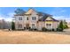 Stately brick home with manicured landscaping and mature trees creating a welcoming curb appeal at 5269 Heron Bay Blvd, Locust Grove, GA 30248