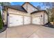 Three car garage with white doors and brick exterior at 5269 Heron Bay Blvd, Locust Grove, GA 30248