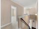 Second floor hallway with carpet floors and a staircase at 5269 Heron Bay Blvd, Locust Grove, GA 30248