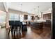 Spacious kitchen boasts dark cabinets, granite countertops, stainless steel appliances, and hardwood floors at 5269 Heron Bay Blvd, Locust Grove, GA 30248