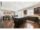 Open kitchen with a granite island, bar seating and stainless steel appliances at 5269 Heron Bay Blvd, Locust Grove, GA 30248