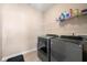 Laundry room with tile floors and side-by-side washer and dryer at 5269 Heron Bay Blvd, Locust Grove, GA 30248