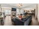 Open-concept living room with fireplace, hardwood floors, and seamless transition to the kitchen at 5269 Heron Bay Blvd, Locust Grove, GA 30248