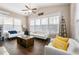 Bright living room with ample natural light, hardwood floors, and comfortable seating arrangement at 5269 Heron Bay Blvd, Locust Grove, GA 30248