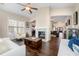 Stylish living room with hardwood floors, a fireplace, and views into the kitchen and entryway at 5269 Heron Bay Blvd, Locust Grove, GA 30248