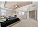 Comfortable main bedroom with trey ceiling, fireplace, and view to other rooms at 5269 Heron Bay Blvd, Locust Grove, GA 30248