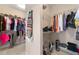 Walk-in closet with multiple racks and shelves, ideal for organizing clothes and accessories at 5269 Heron Bay Blvd, Locust Grove, GA 30248
