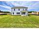 Spacious backyard with lush green grass and a covered patio, perfect for outdoor entertaining and relaxation at 679 Crest Line Trl, Powder Springs, GA 30127