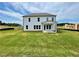 Expansive lawn behind a two story home featuring a covered patio at 679 Crest Line Trl, Powder Springs, GA 30127
