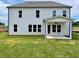 Spacious backyard featuring a newly built two-story home and covered patio at 679 Crest Line Trl, Powder Springs, GA 30127
