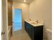 Bathroom featuring a double sink vanity and adjacent room with bathtub and shower at 679 Crest Line Trl, Powder Springs, GA 30127
