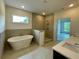 Bright bathroom offers a soaking tub, separate shower, and double vanity with modern fixtures at 679 Crest Line Trl, Powder Springs, GA 30127