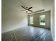 Spacious main bedroom with large windows, tray ceiling, and a ceiling fan at 679 Crest Line Trl, Powder Springs, GA 30127