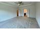 The expansive bedroom features a ceiling fan and connects to the ensuite bathroom at 679 Crest Line Trl, Powder Springs, GA 30127