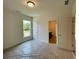 A bedroom with neutral tones, a window, and an adjacent bathroom for added convenience at 679 Crest Line Trl, Powder Springs, GA 30127