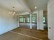 Dining room with chandelier, neutral paint, and a view into the living room at 679 Crest Line Trl, Powder Springs, GA 30127
