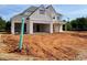 Home under construction, displaying white brick, a spacious garage, and unfinished landscaping at 679 Crest Line Trl, Powder Springs, GA 30127