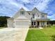 Inviting two-story home with white brick, light turquoise shutters and professionally landscaped front yard at 679 Crest Line Trl, Powder Springs, GA 30127