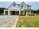 New construction home shows white brick and siding, a spacious driveway, and fresh sod installation at 679 Crest Line Trl, Powder Springs, GA 30127