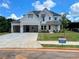 Exterior of new construction home boasting a three-car garage, brick and siding accents, and manicured front lawn at 679 Crest Line Trl, Powder Springs, GA 30127