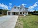 A beautiful, newly-built two-story home features light brick, white painted siding and a three car attached garage at 679 Crest Line Trl, Powder Springs, GA 30127