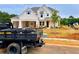 Beautiful newly constructed home with a white brick facade, charming gables, and a well manicured lawn at 679 Crest Line Trl, Powder Springs, GA 30127