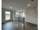 Hallway with wood flooring, white walls, and natural light from a window overlooking a field at 679 Crest Line Trl, Powder Springs, GA 30127