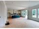 Unfinished kitchen reveals modern white cabinetry, a center island, and abundant natural light from large windows at 679 Crest Line Trl, Powder Springs, GA 30127