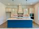 Modern kitchen featuring a blue island, ample counter space, and sleek stainless-steel appliances at 679 Crest Line Trl, Powder Springs, GA 30127
