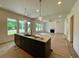 Spacious kitchen featuring a central island with a sink, connecting to the dining and living area at 679 Crest Line Trl, Powder Springs, GA 30127