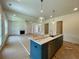 Large kitchen island with stainless steel dishwasher and sink, set in an open-concept living space at 679 Crest Line Trl, Powder Springs, GA 30127