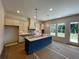 Well-lit kitchen features an island, a decorative tile backsplash, and lots of windows at 679 Crest Line Trl, Powder Springs, GA 30127